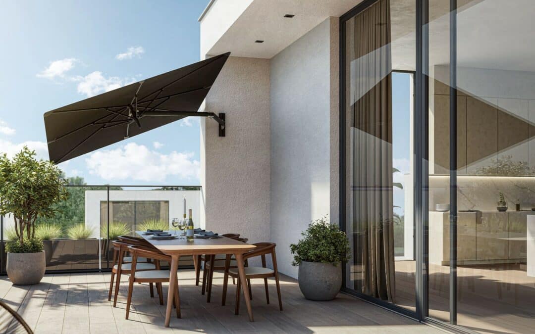 Terrasse moderne avec table en bois dressée sous grand parasol mural noir donnant sur une terrasse